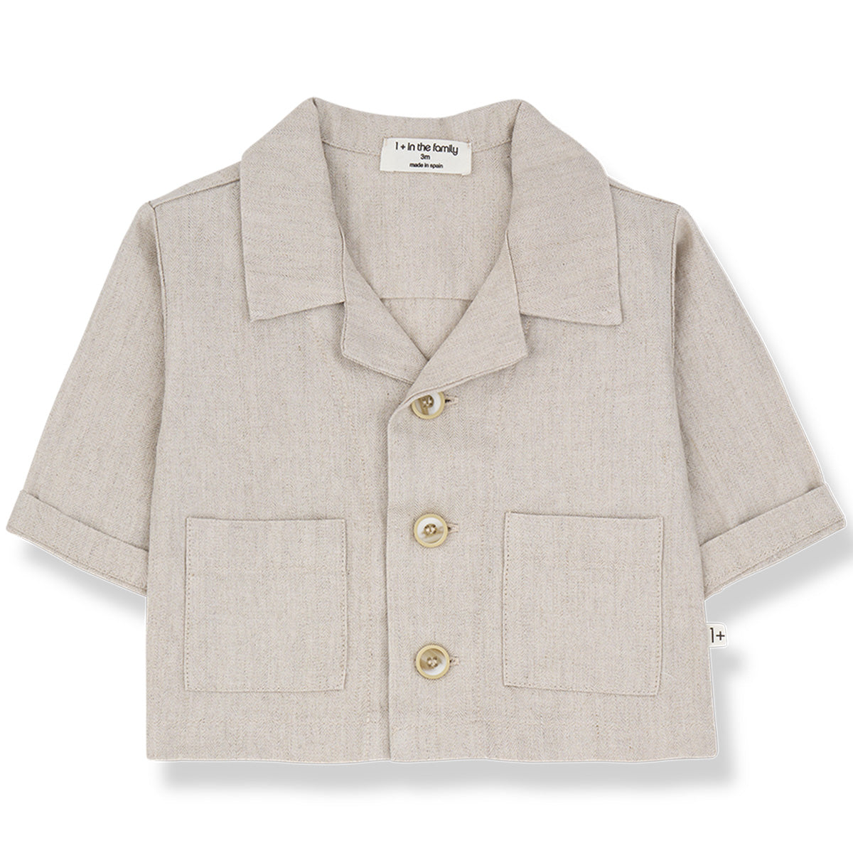 The Peratallada Jacket from 1+ in the Family in beige with collar, front buttons, rolled sleeves, and patch pockets.