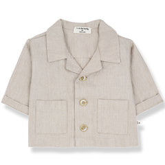 The Peratallada Jacket from 1+ in the Family in beige with collar, front buttons, rolled sleeves, and patch pockets.