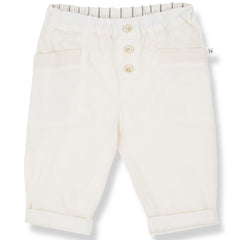 The Portbou Pants from 1+ in the Family in off-white with elastic waistband, front buttons, patch pockets, and rolled cuffs.