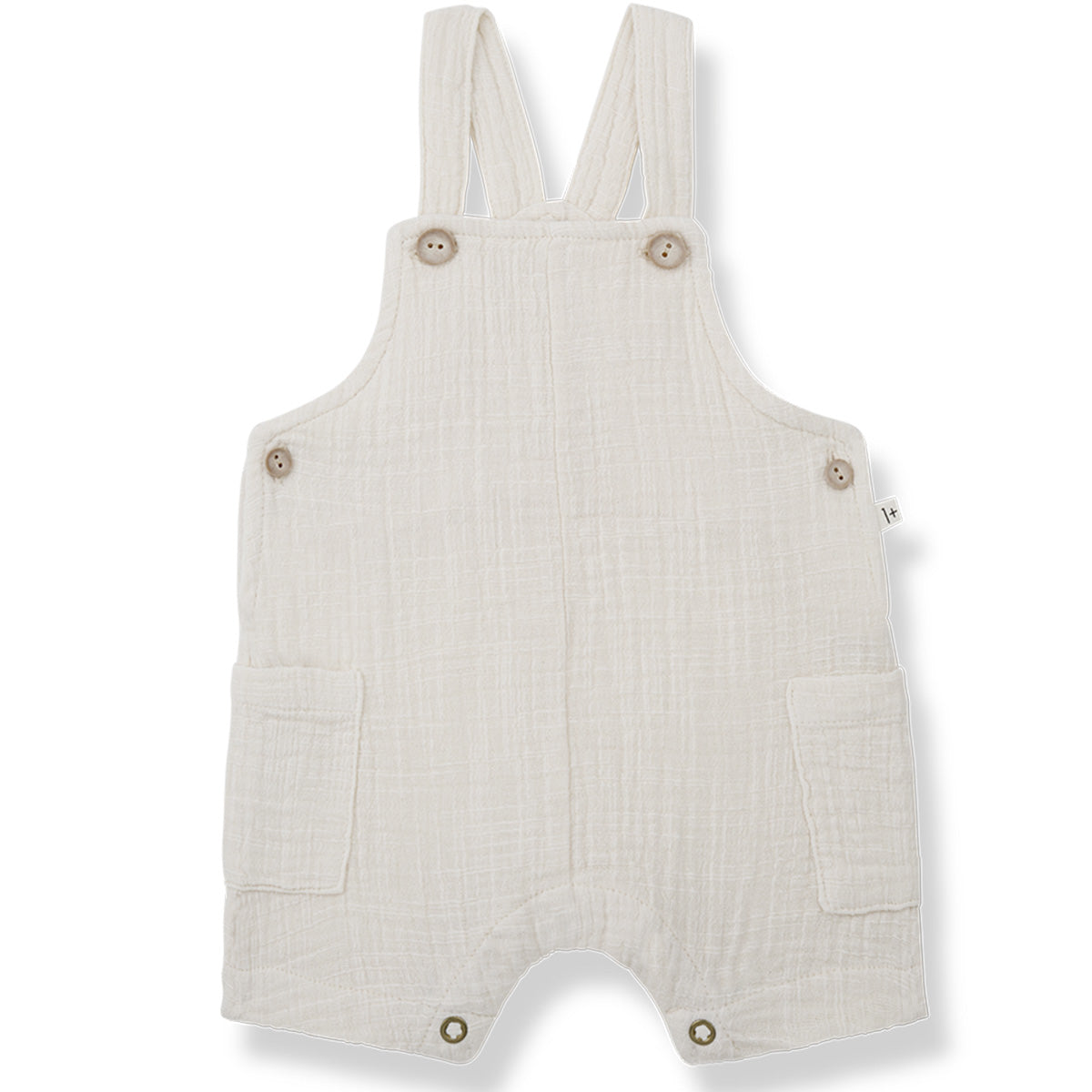 The Roman Overall from 1+ in the Family. Adorable and comfy off-white baby overalls made from soft, textured fabric. 