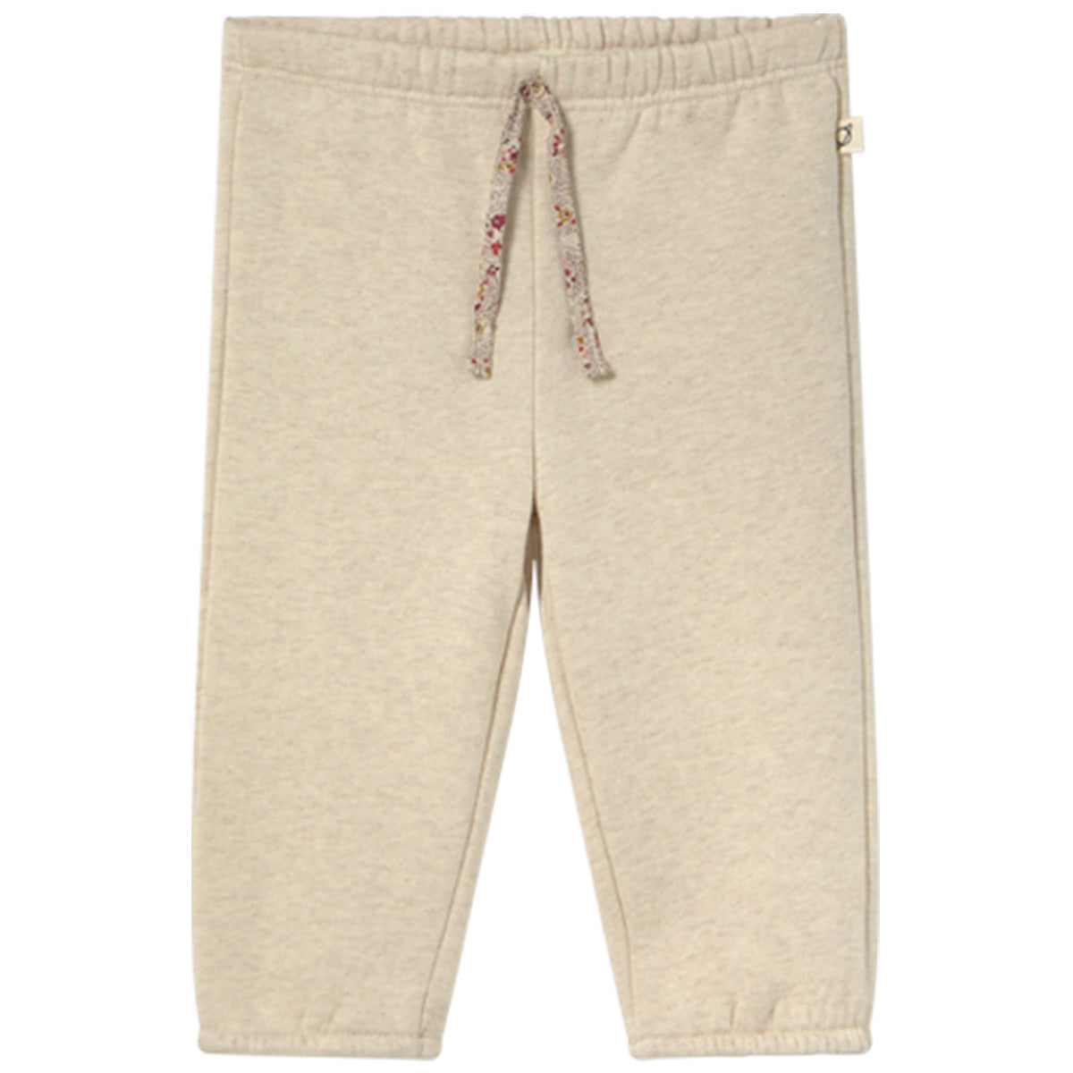 The Siria Pants from Cozmo. A pair of cozy beige fleece pants with an elastic waistband and floral drawstring tie.
