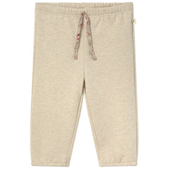 The Siria Pants from Cozmo. A pair of cozy beige fleece pants with an elastic waistband and floral drawstring tie.