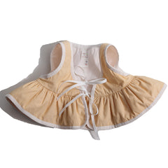 Ophelia Peplum Padded Vest from Tia Cibani. Lightly padded vest. With a peplum flare at hem. Ribbon ties at front