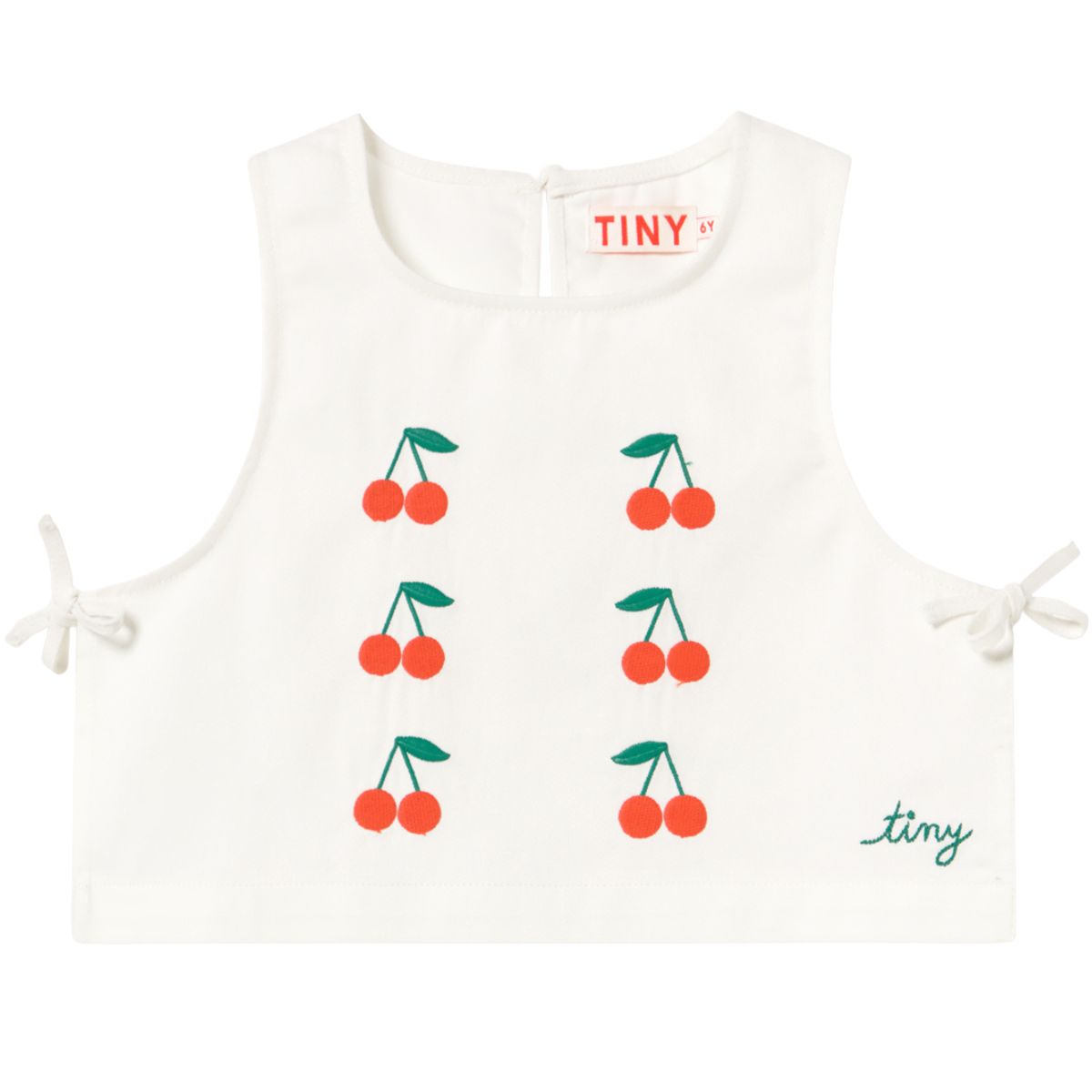 The Mini Cherries Twill Top by Tiny Cottons, off-white sleeveless top with cherry embroidery and side tie details.