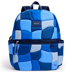 The Kane Double Pocket Backpack from State Bags. Blue quilted backpack with 'STATE' label on a white background.