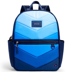 State Bags Kane Backpack with blue quilted chevron pattern, front zip pocket, and logo patch