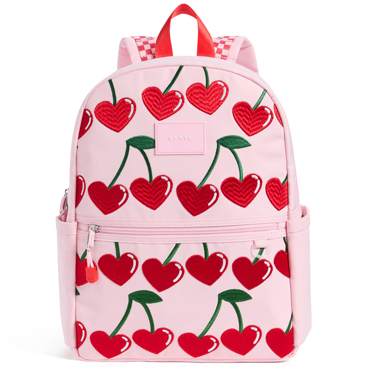 State Bags Kane Backpack in pink with heart cherry print, front zip pocket, top handle, and logo patch