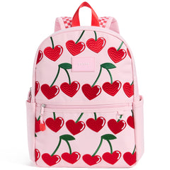 State Bags Kane Backpack in pink with heart cherry print, front zip pocket, top handle, and logo patch