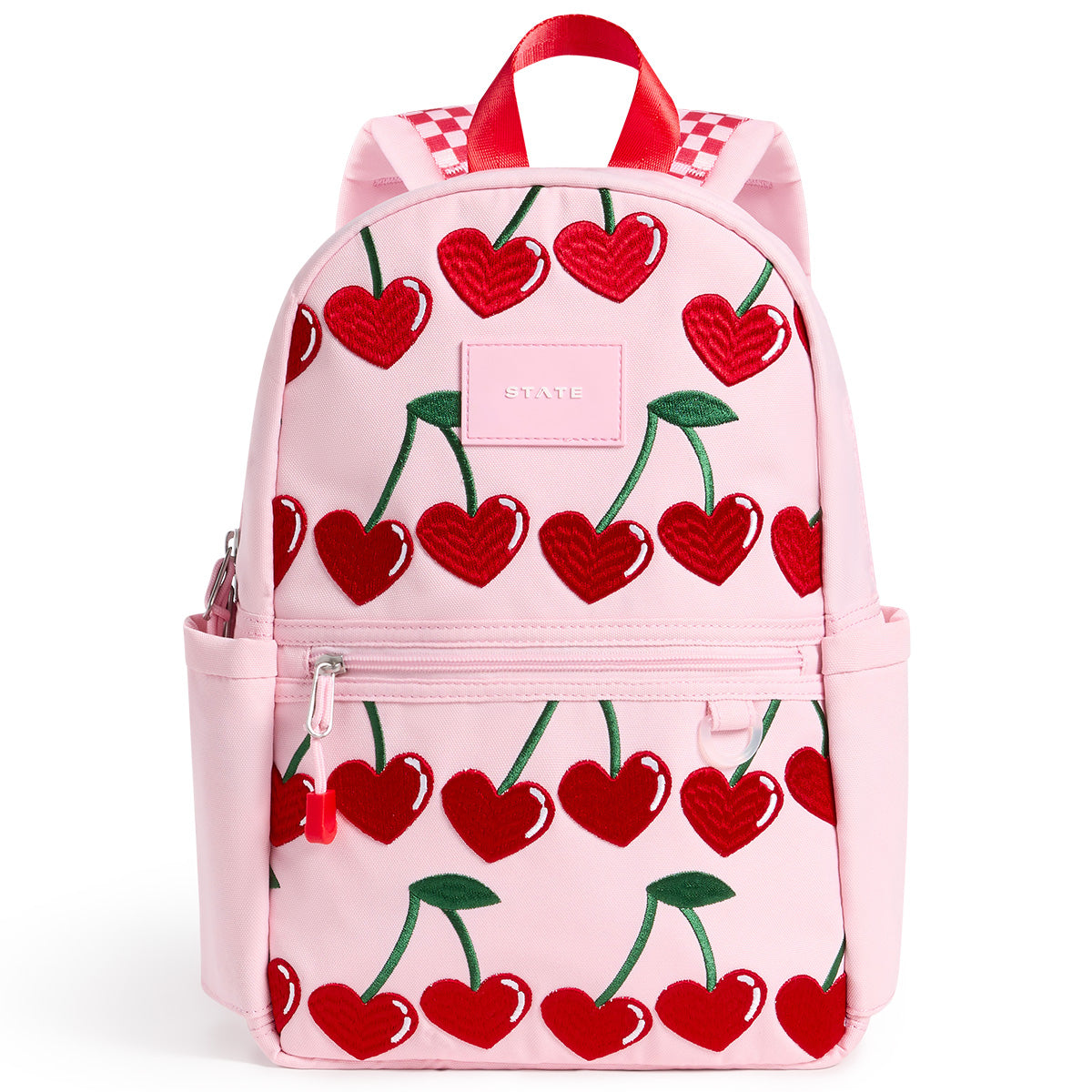 State Bags Kane Mini Backpack in pink with cherry print, front zip pocket, side pockets, top handle, and logo patch