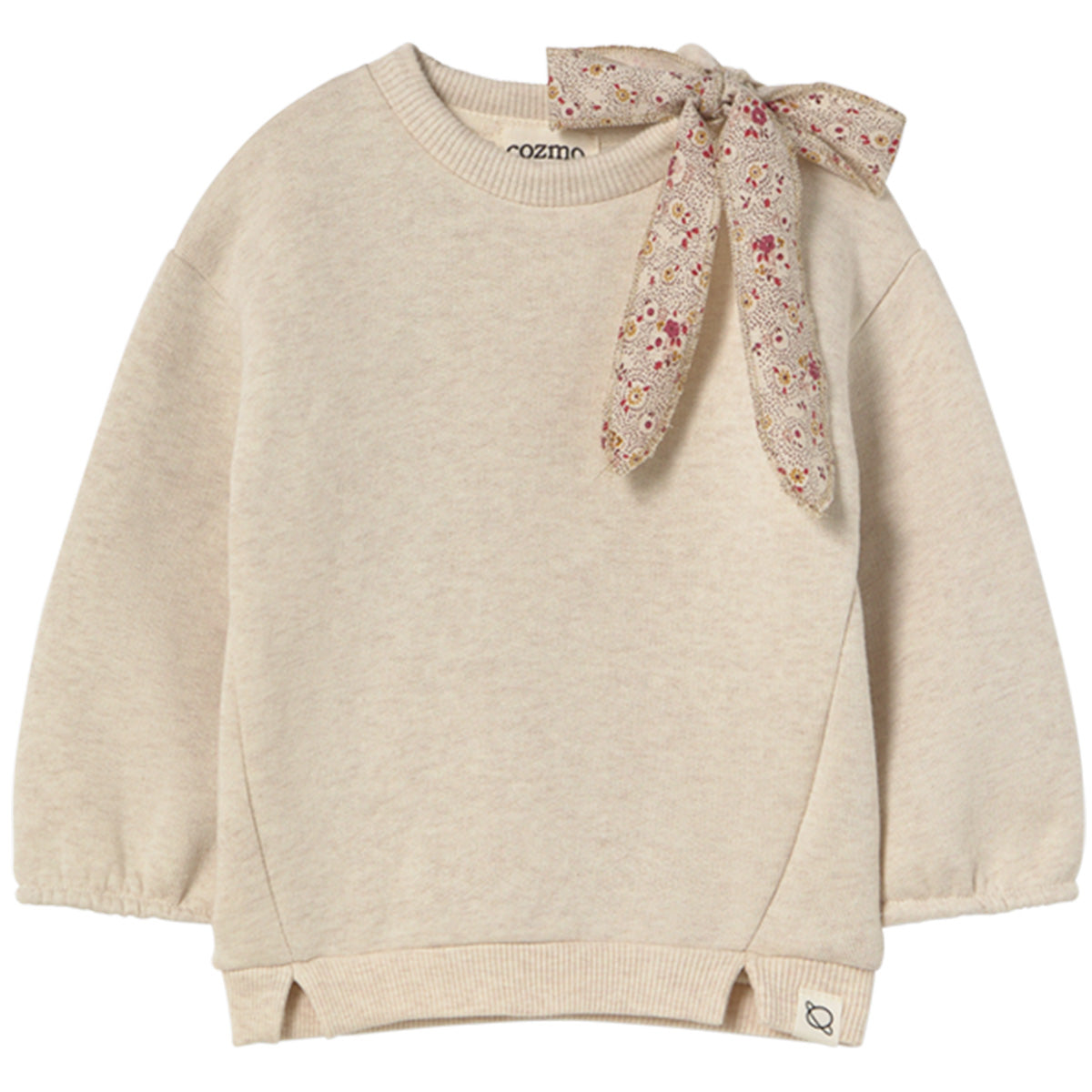 The Suecia Sweatshirt from Cozmo. Beige sweater with a floral scarf tied around the neck on a white background.
