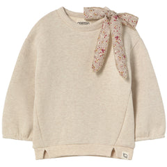 The Suecia Sweatshirt from Cozmo. Beige sweater with a floral scarf tied around the neck on a white background.