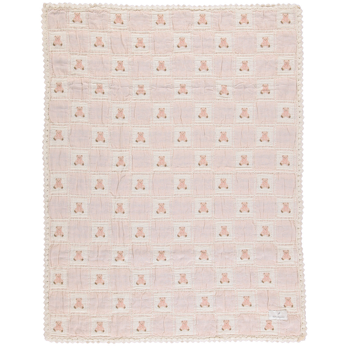 The Teddy Blanket from Bebe Organic featuring a knitted patchwork design with a signature bear motif and lace border trim.