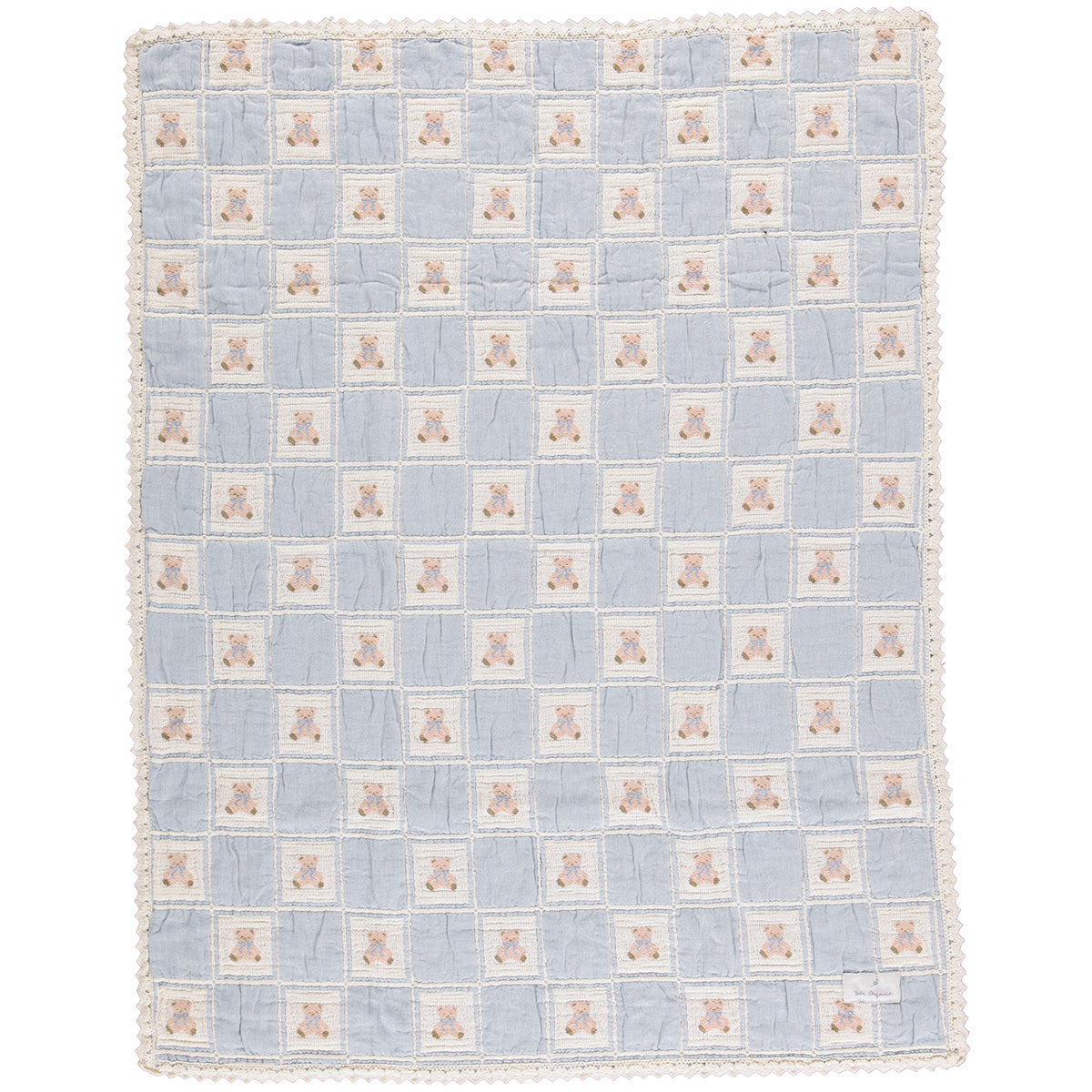 The Teddy Blanket from Bebe Organic featuring a knitted patchwork design with a signature bear motif and lace border trim.