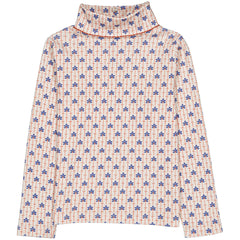 The Twiggy Turtleneck from Hello Simone with an all-over print, crochet collar, long sleeves, and back snap closure.