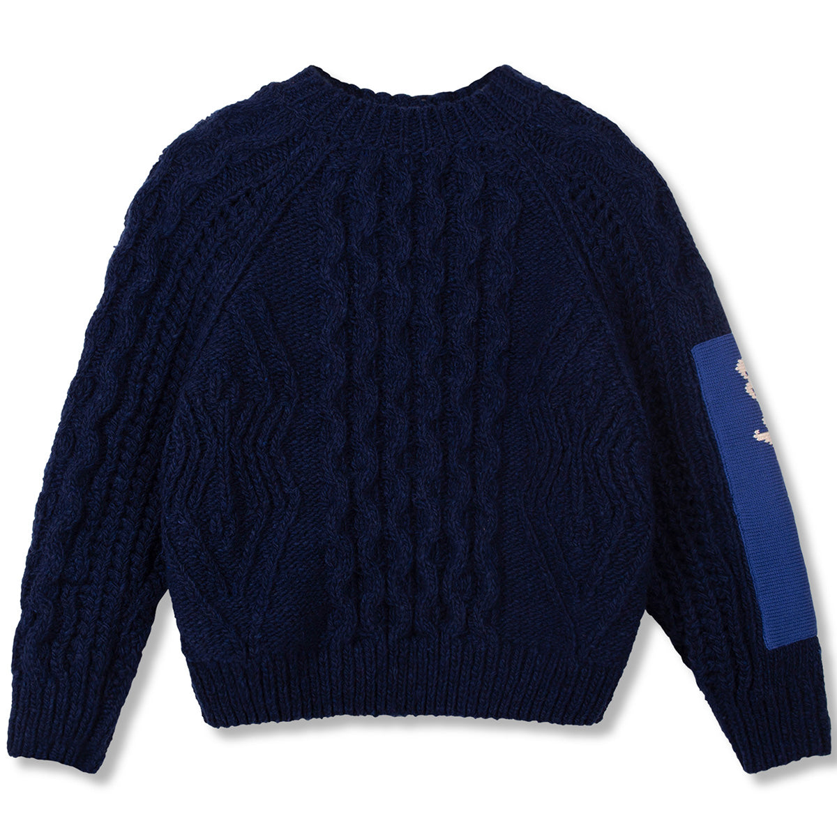 The Aran Knit Sweater by Wynken in navy cable knit with a contrast sleeve patch and classic crew neckline.