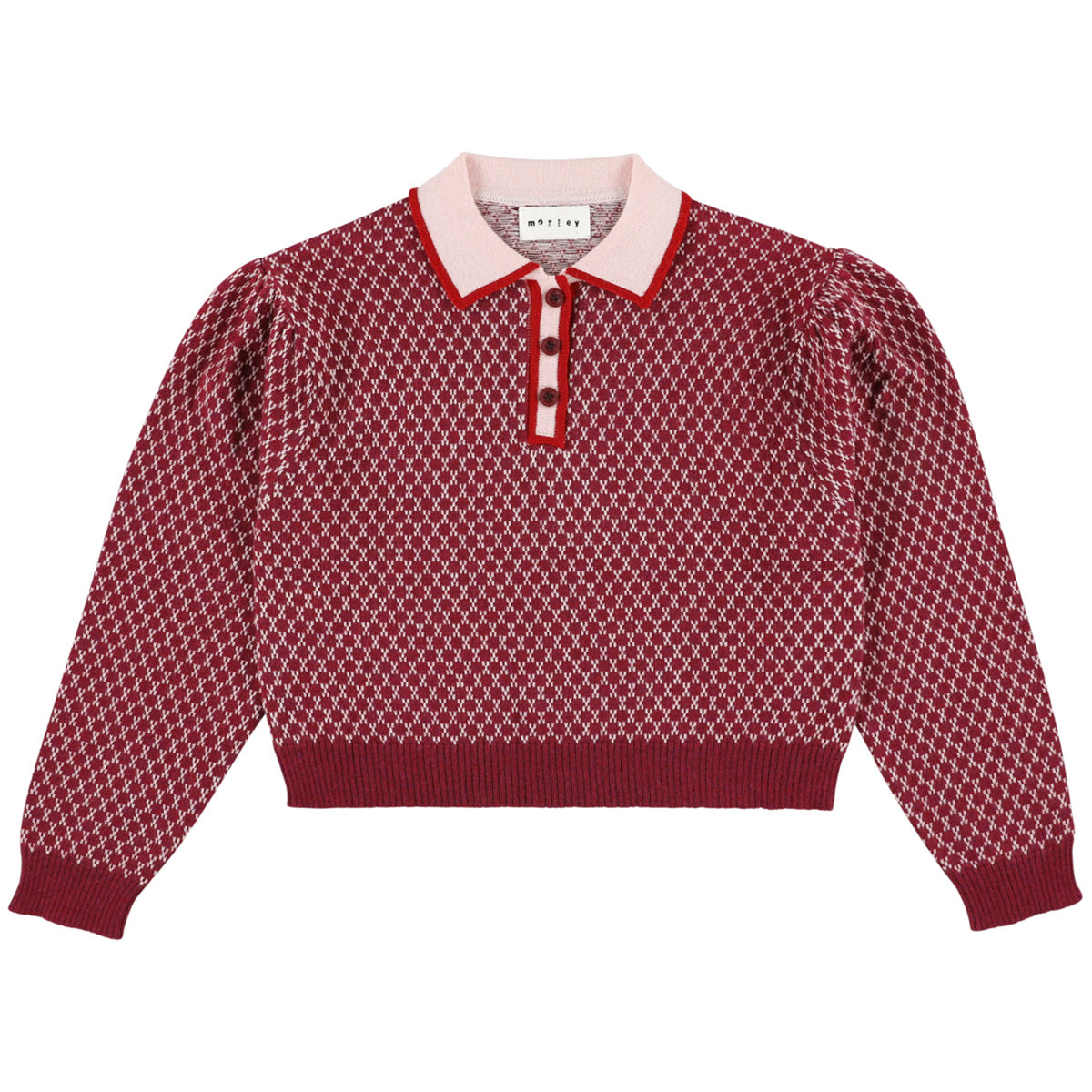 The Zug Polo from Morley in red diamond knit featuring a contrast pink collar and long puff sleeves.