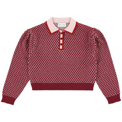 The Zug Polo from Morley in red diamond knit featuring a contrast pink collar and long puff sleeves.