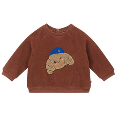 Baby Croissant Sweatshirt by Arsene et Les Pipelettes with croissant graphic and blue beanie.