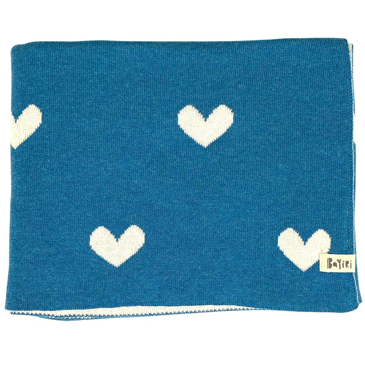 The Moon Phases Blanket from Bayiri. Blue blanket with white heart patterns and a brand label on a white background.