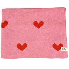 The Moon Phases Blanket from Bayiri. This is a knitted baby blanket in soft pink, patterned with bold red hearts.