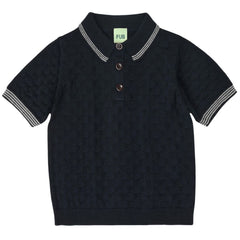 The Polo from FUB. Dark navy short-sleeve polo shirt with white trim on a white background.