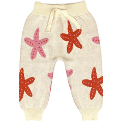 Starfish Dance Pants by Bayiri. Baby knitted pants in a cream base, featuring playful starfish motifs in pink and red.
