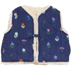 The Reversible Flower Baby Vest from Arsene et Les Pipelettes in navy with a colorful floral print and fleece trim.