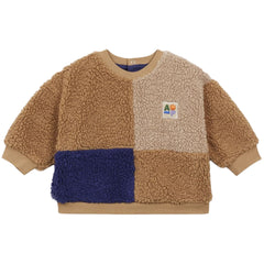 The Sherpa Patch Baby Sweatshirt from Arsene et Les Pipelettes in color-blocked brown, beige, and navy sherpa fleece.